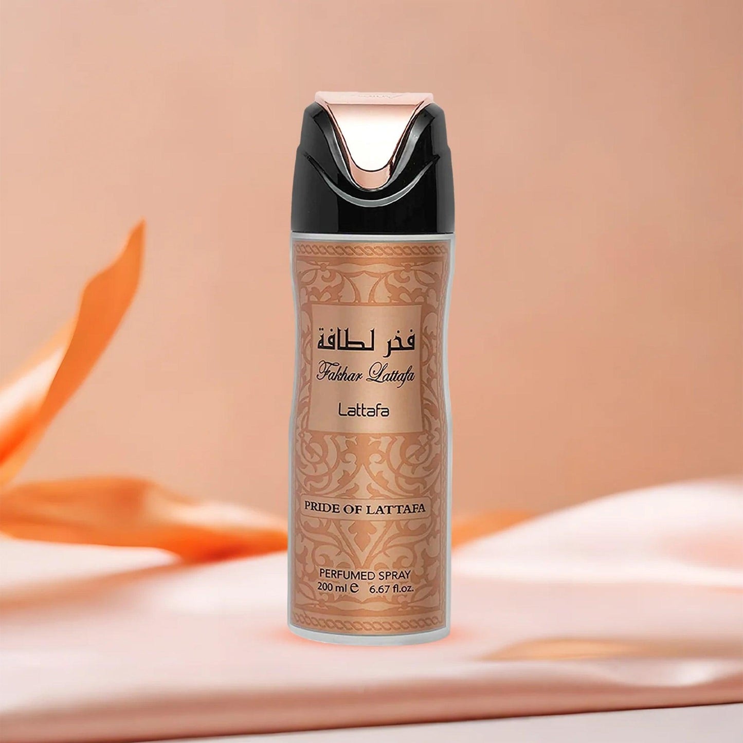 Lattafa Fakhar Pride of Lattafa perfumed spray in a gold and black bottle placed on a soft peach fabric background with elegant lighting