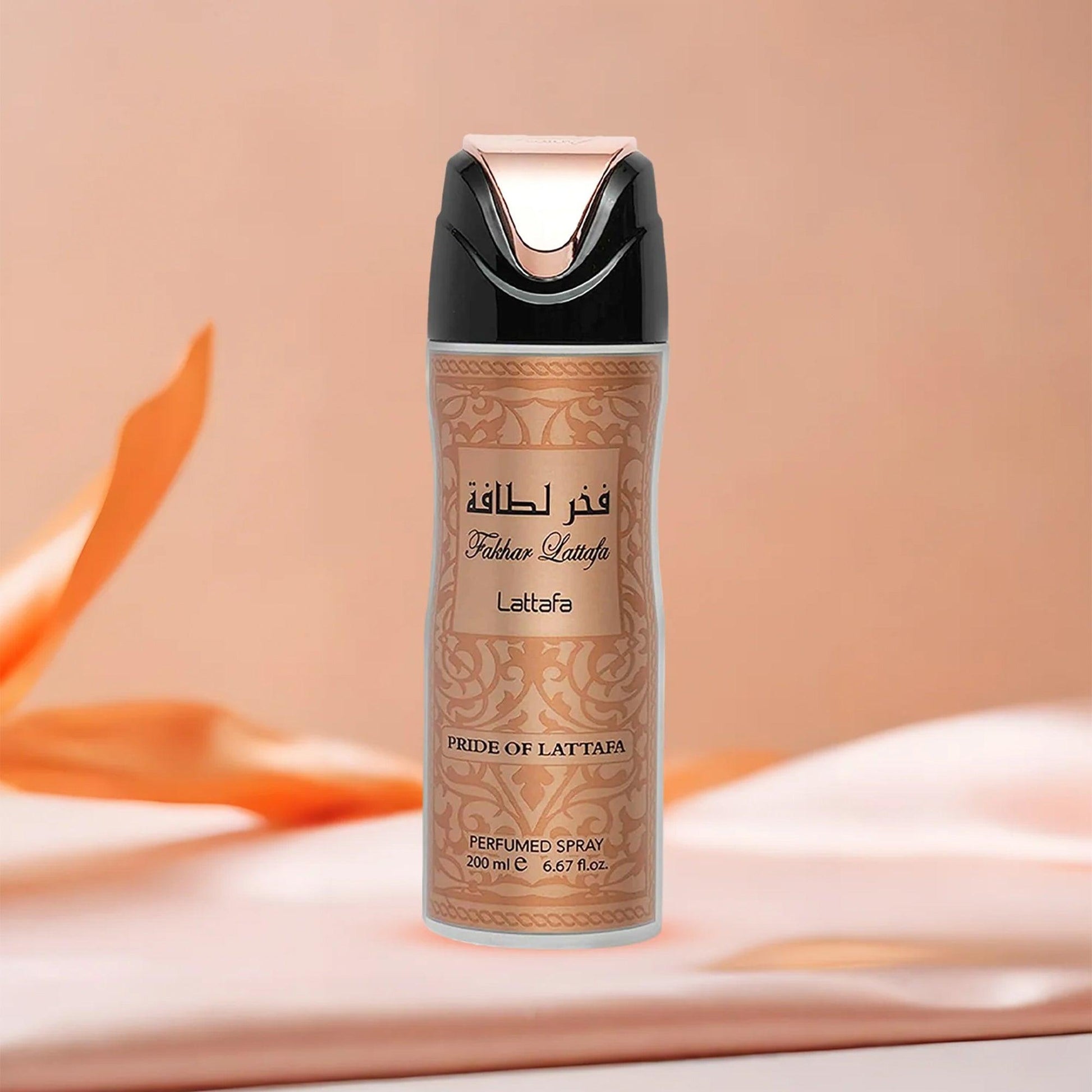 Lattafa Fakhar Pride of Lattafa perfumed spray in a gold and black bottle placed on a soft peach fabric background with elegant lighting