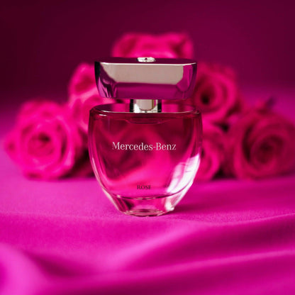 Mercedes-Benz Rose Eau De Parfum bottle on pink background with roses.