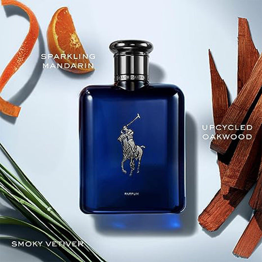 Ralph Lauren Polo Blue Parfum bottle in deep blue color placed on a light background surrounded by sparkling mandarin slices, smoky vetiver leaves, and upcycled oakwood pieces.