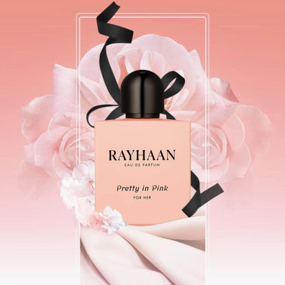 Rayhaan Pretty in Pink For Her Eau De Parfum bottle with black ribbon detailing, placed against a soft pink floral background with roses