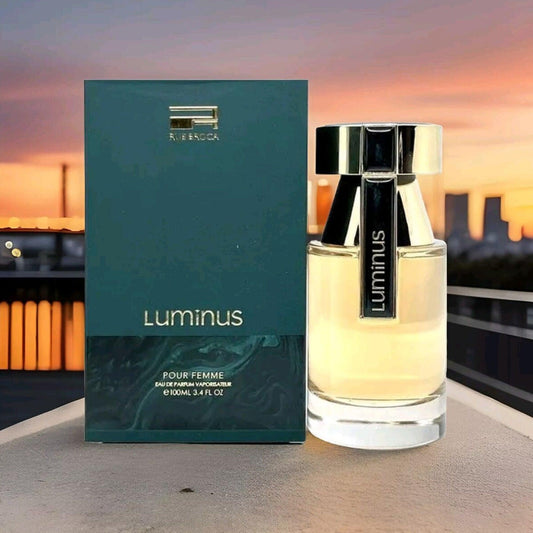 Rue Broca Luminus Pour Femme fragrance bottle and box against evening skyline