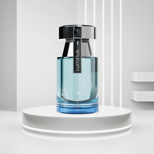 Rue Broca Luminous Eau De Parfum bottle in sleek blue glass design with black cap displayed on a glowing white pedestal background
