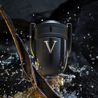 Paco Rabanne Invictus Victory Eau De Parfum trophy-shaped black bottle with gold V logo surrounded by splashing water and dark wooden elements